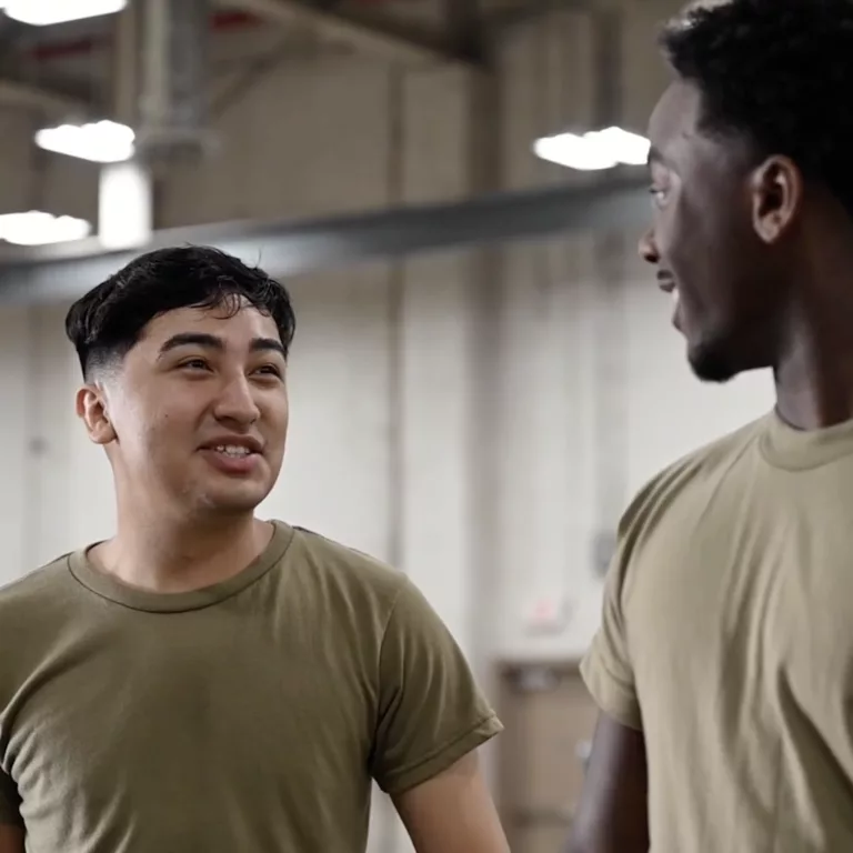 Two Men In Military Gear Conversing